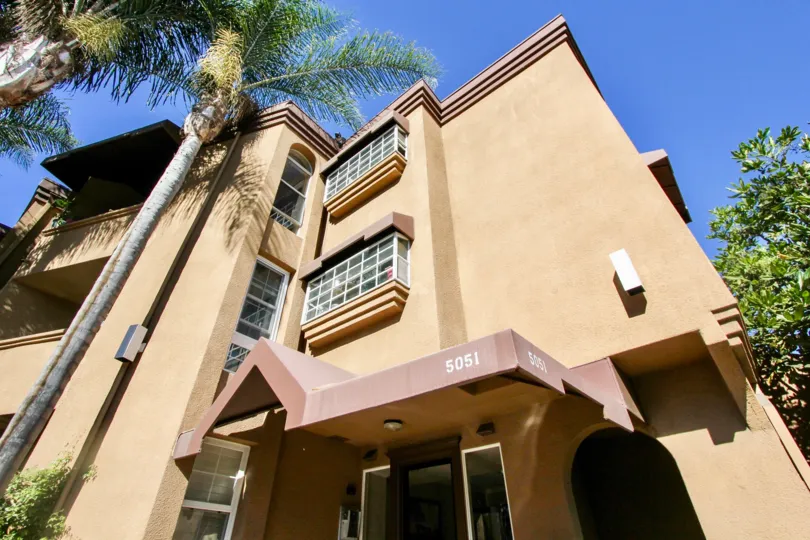 A sunny day in La Jolla Bella with villa with portigo and trees around in Pacific Beach