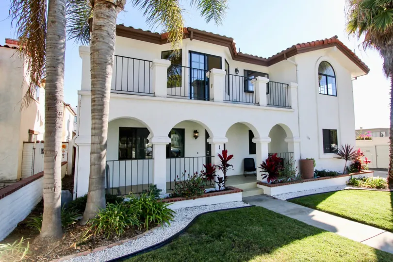The La Jolla Mesa front side with lush green grass and potted plants