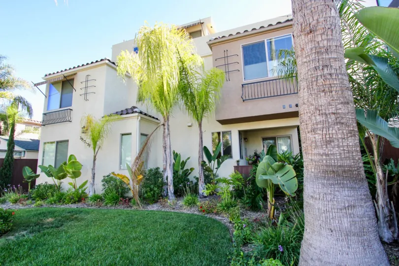 Exterior view showing the lush tropical landscaping of Lamont Street Townhomes in Pacific Beach, CA