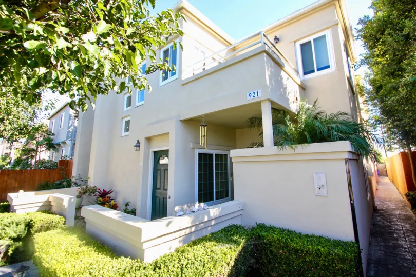 A two-storey residence with a low fence and painted in white color in Law Street community.