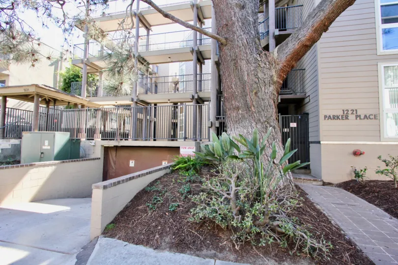 Entrance to apartment building with a metal gate and stone walkway at Mission Bay Parker Place in Pacific Beach, Ca.