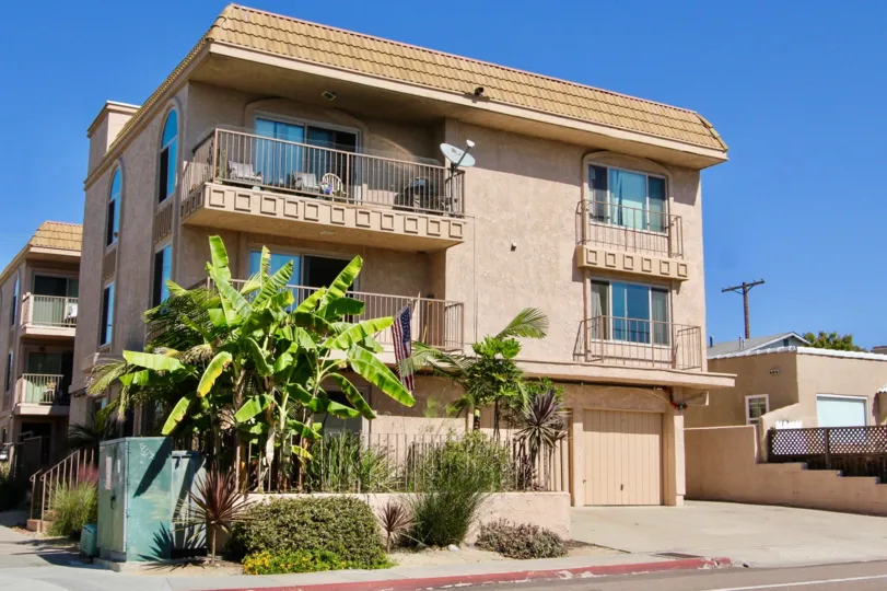 A sunny day in the area of Mission Bay Shores East, outside, american flag, balcony, condos, tree