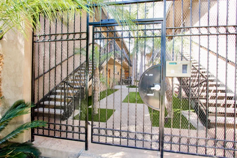 The privacy gate entrance of the Missouri Pacific apartment complex, shwoing a portion of the courtyard.