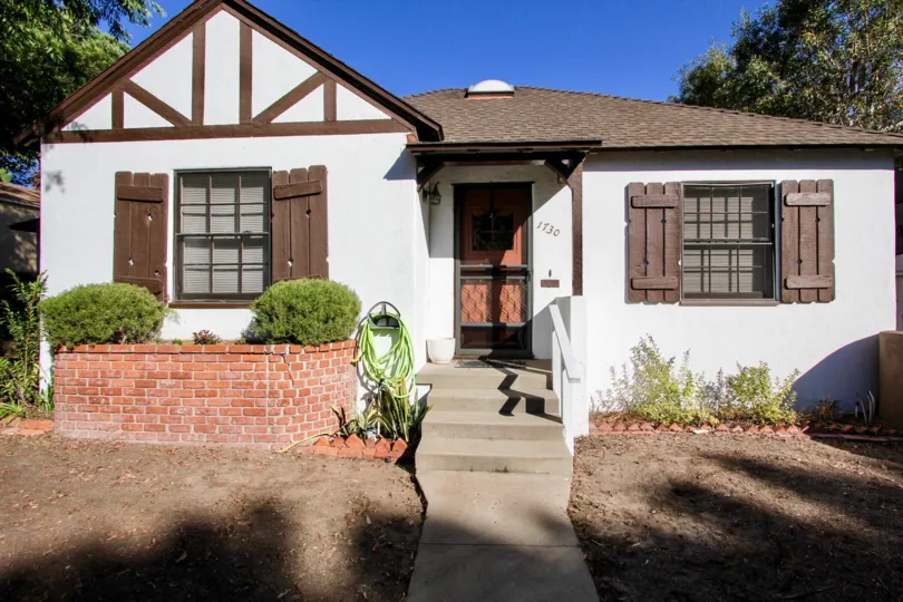 A lodge-style bungalow in the Oliver Homes community with wooden shutters.