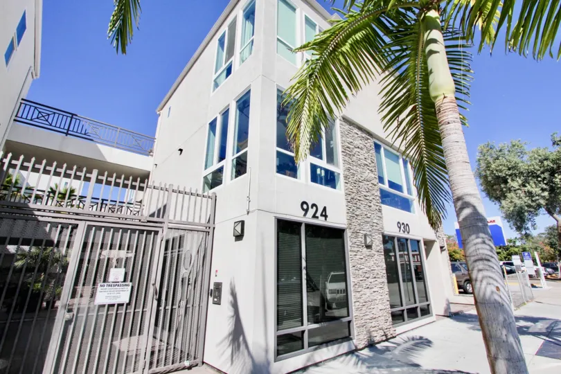 The apartment 924, 930 has glass windows and with trees in front of it