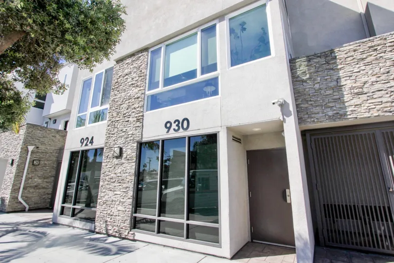 A sunny day in the Pacific Beach Sands with residential building and glass windows.