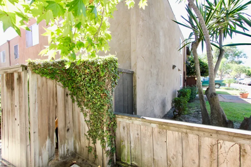 back fence view covering a grey building in pacific beach villas