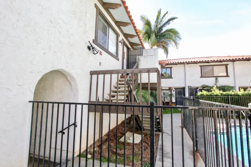 A sunny day in the area of Pacific Pines, outside, stairs, palm tree, light, condo