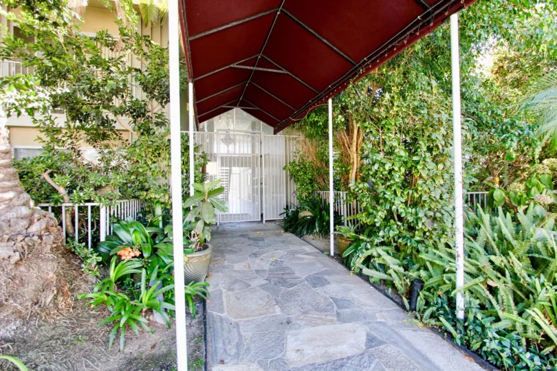 Lush, tropical landscaping and covered entry to Pacific Plaza Terrace.