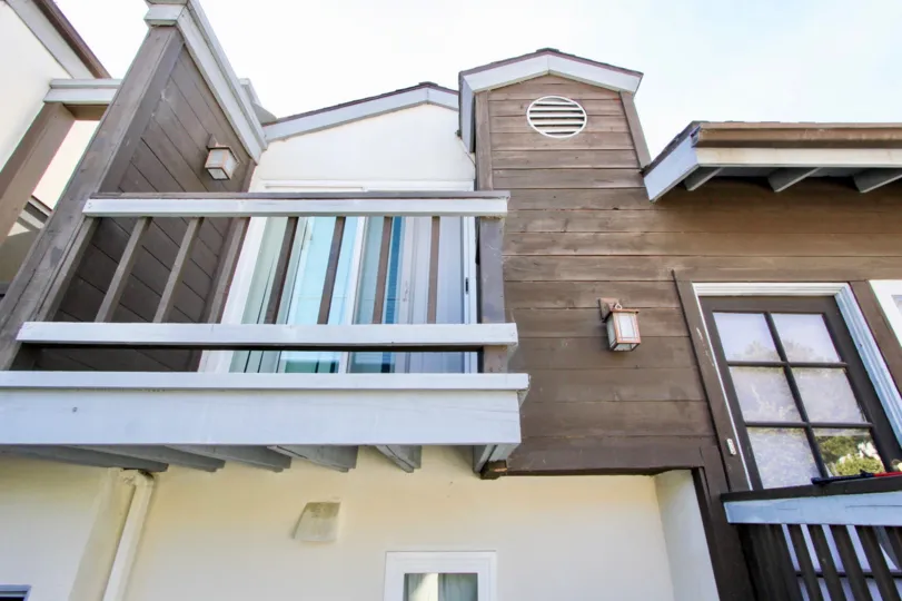 A two-storey residence with wooden cladding in the Pacifica Townhomes community.