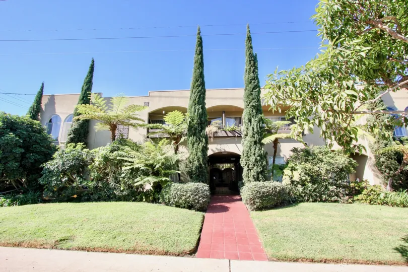 A Bright sunny and serene atmosphere with trees and lawn in front of a House in Portofino of Pacific Beach