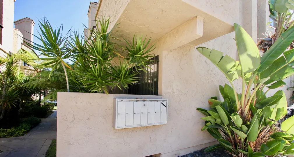 locked mail box biew of the promontory townhomes containing many small palm trees