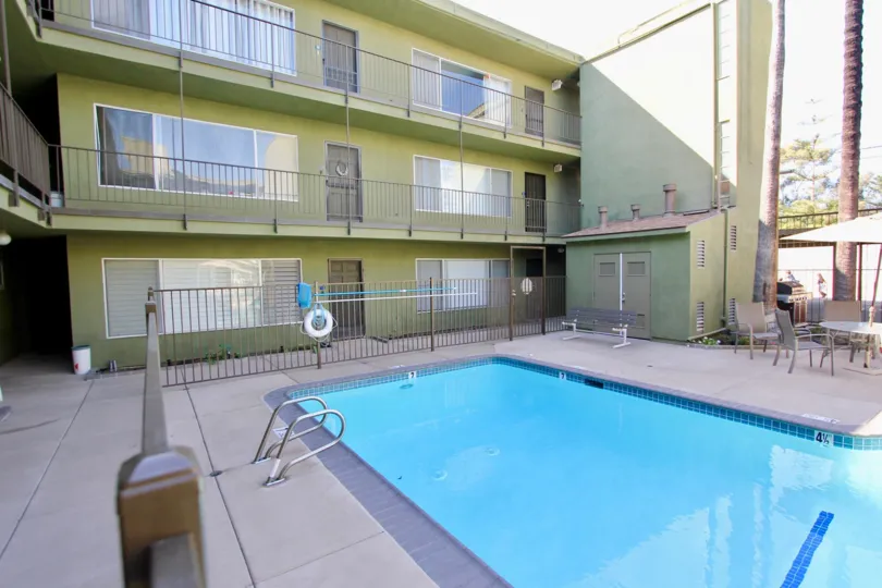 A small pool around three-storey townhouses in the Regency Condos community.