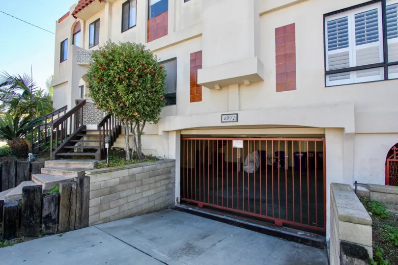 A sunny day in the area of Riviera Cove, outside, stairs, condos, palm trees, gate