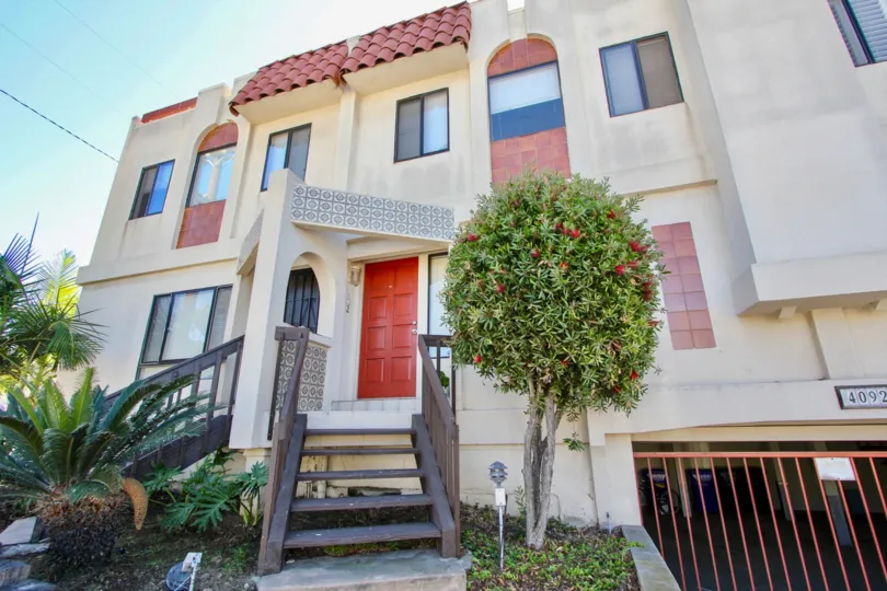 A sunny day in the area of Riviera Cove, outside, stairs, condos, palm trees, flowers