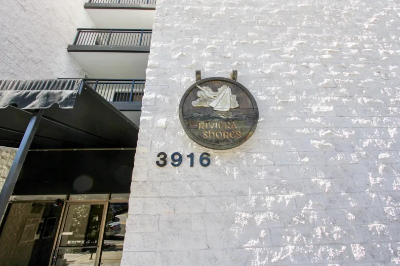 A metal board is attached in wall should mentioned Riviera Shores with 3916 number