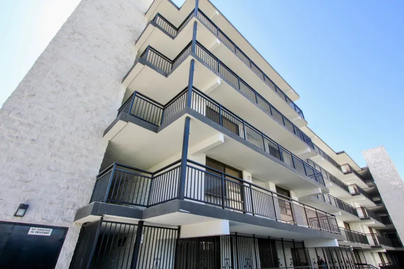 a sunny day in the riviera shores with atall building that has four stories in it