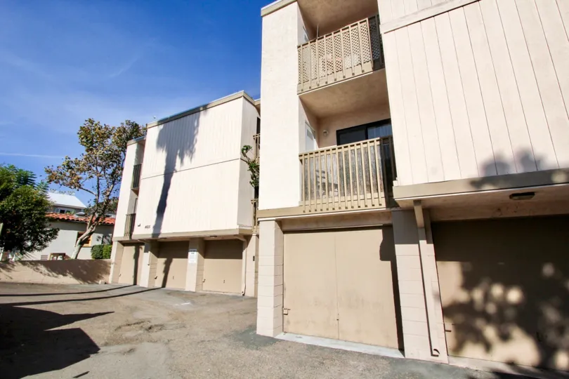 Large tree shadows cast on garage doors of Rose Creek, Pacific Beach, California