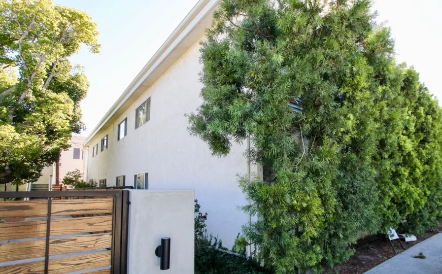 side view of a house in Rose Point with trees running along the wall