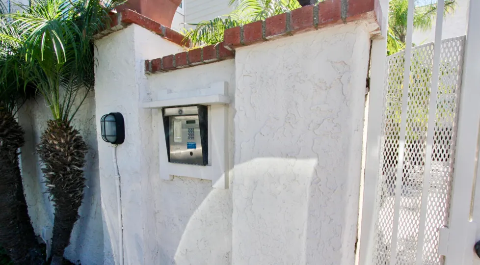 A light next to an intercom on a white wall at Sail Bay Shores in Pacific Beach CA