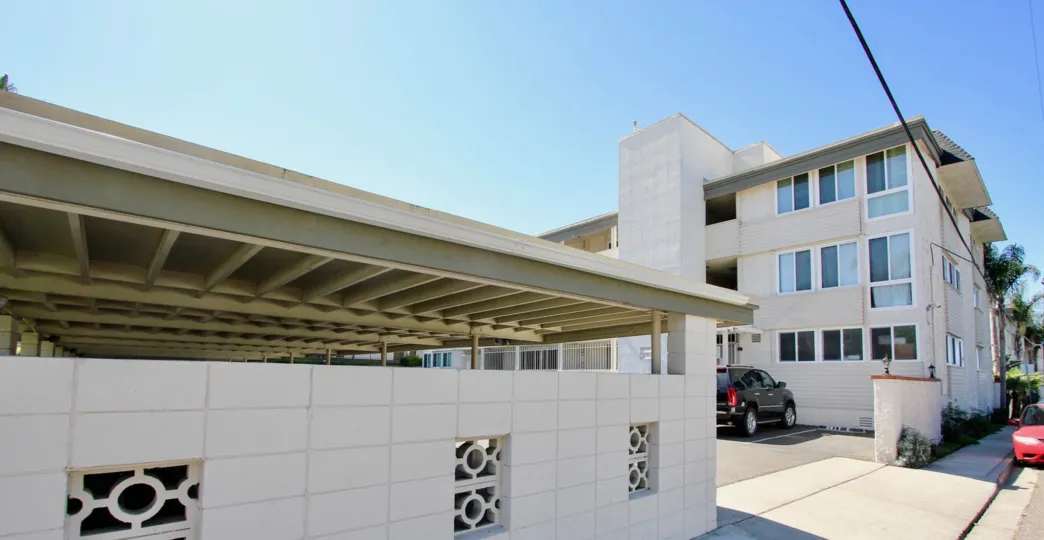 THE HOUSE IN THE SAIL BAY SHORES WITH THE CAR PARKING, TREES