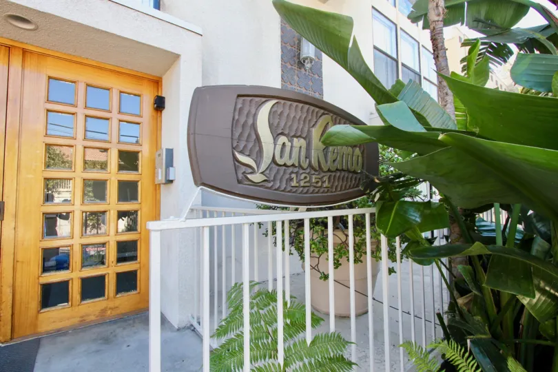 Large signage for brown doors in front of San Remo, Pacific Beach, California
