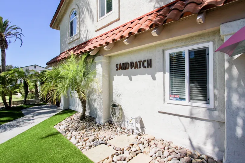 A two-storey building with a signage in the Sand Patch community.