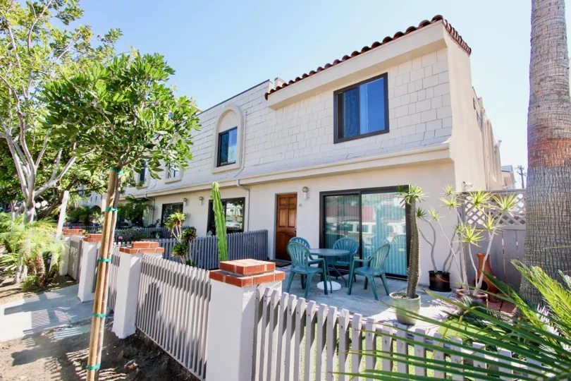 Street - level decks with trees and seating in at Santa Barbara Community in Pacific Beach, CA