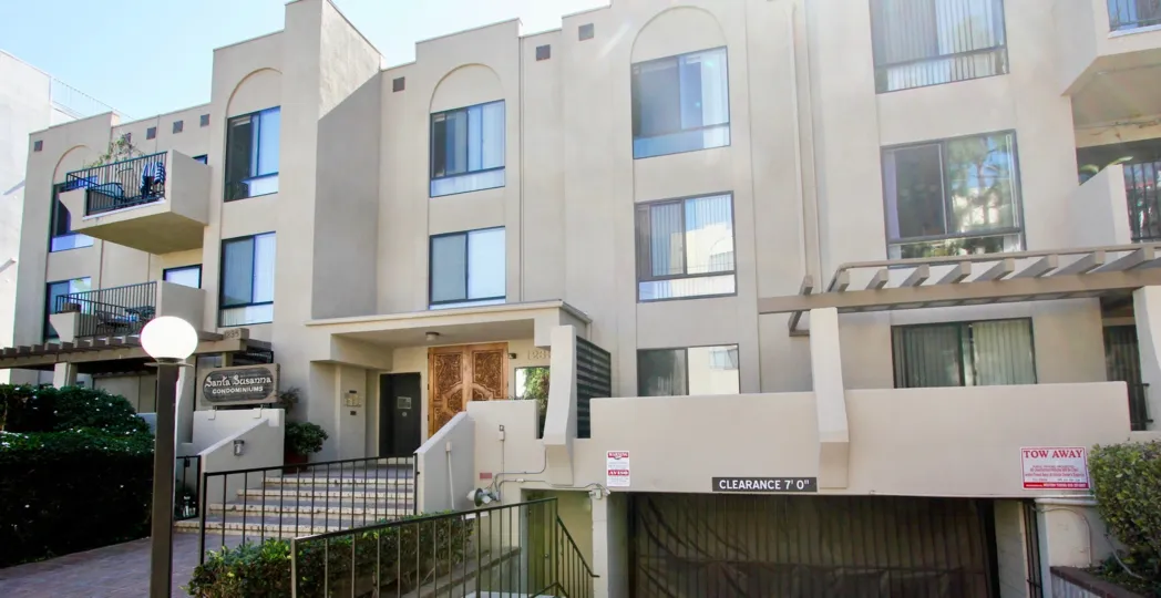 A sunny day in the area of Santa Susanna, outside, railing, stairs, door, light post, condos