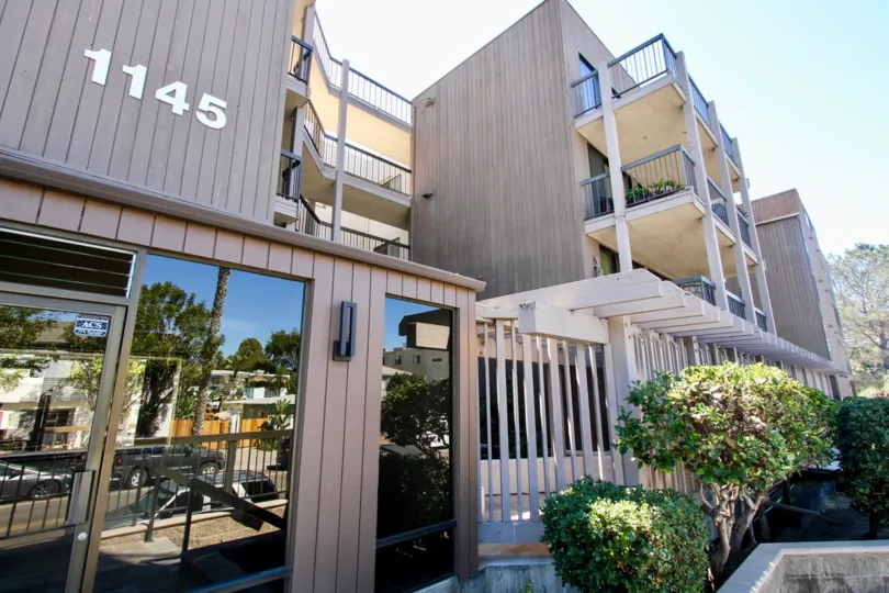 The exterior of a residential apartment building on a sunny day.