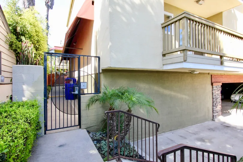 THE APARTMENT IN THE SEA2BAY WITH THE CAR PARKING, PLANTS, TREES, BLUE COLOR GATE, BALCONI