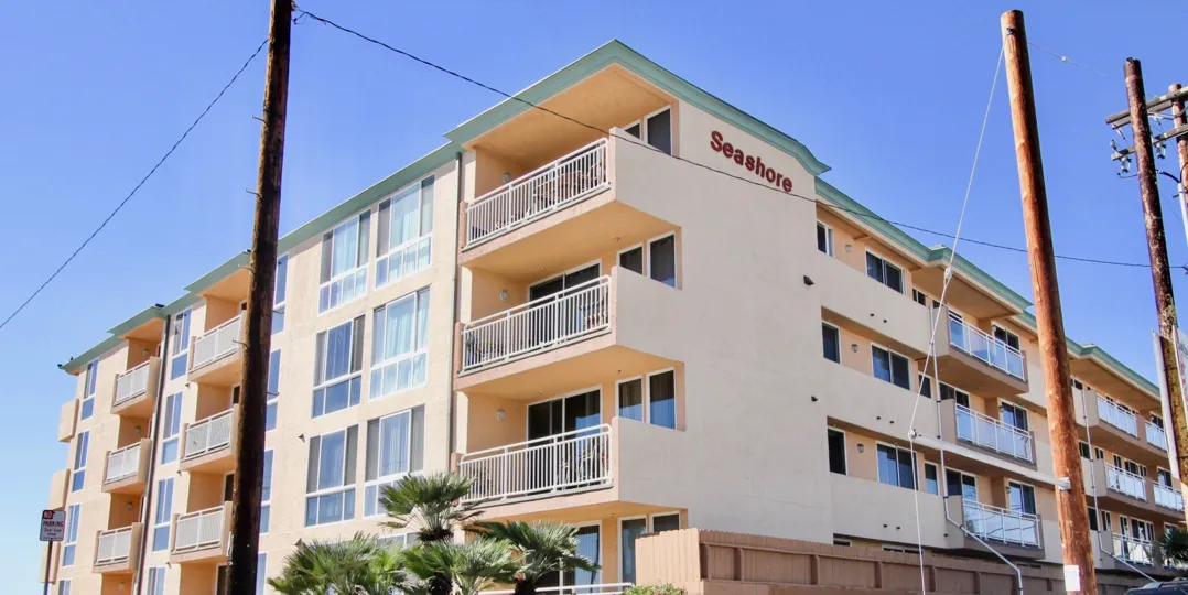 building inpacific Beach, California, hotel or condo in a sunny day with poles in front