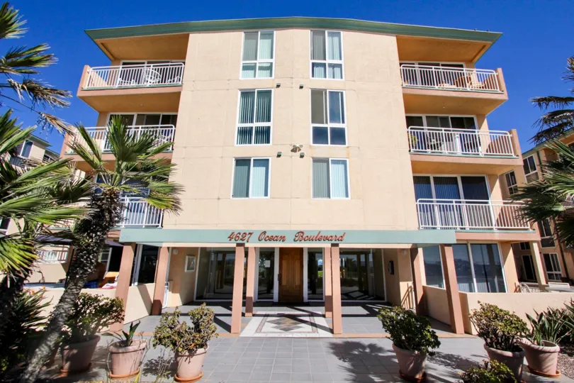 A sunny day in the area of Seashore, outside, balconies, palm trees, entrance door