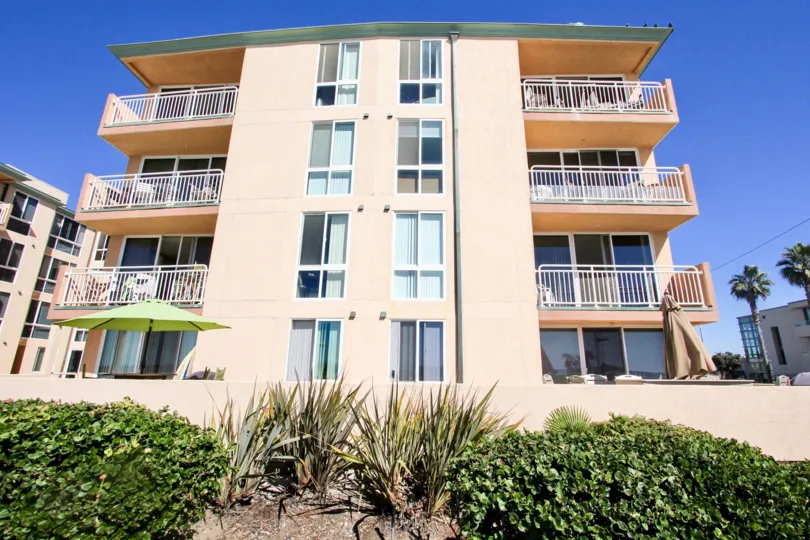 A sunny day in the area of Seashore, outside, balconies, umbrella, palm trees