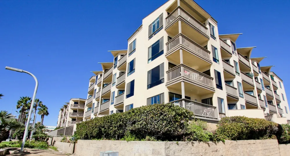 A series of mid-rise townhomes with corner terraces in the See the Sea neighborhood.