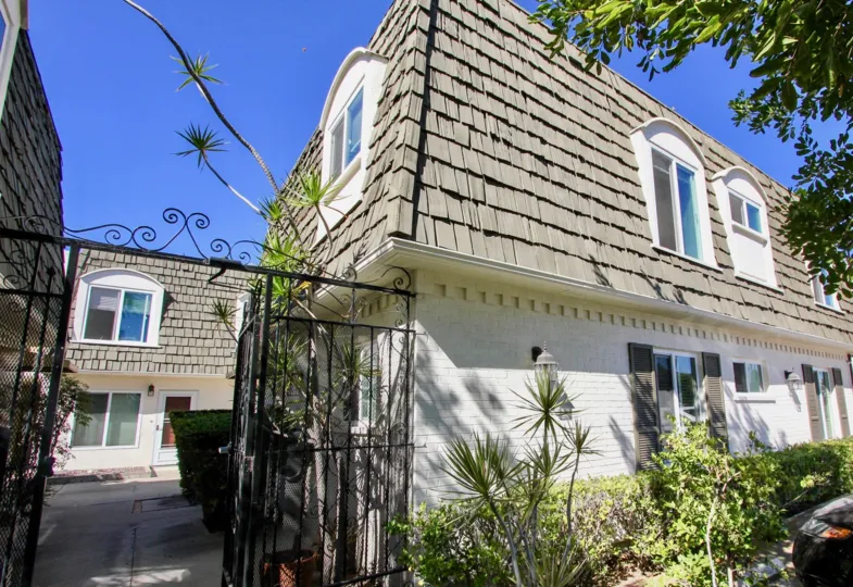 Front of home with gate on side in Shasta Palms community of Pacific Beach, CA