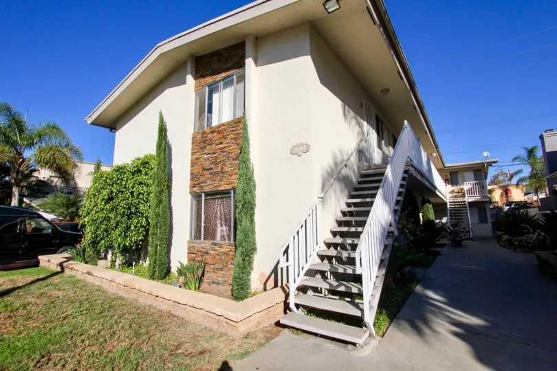 A two story condominium withbricks around it's windows at Sunblend in Pacific Beach CA
