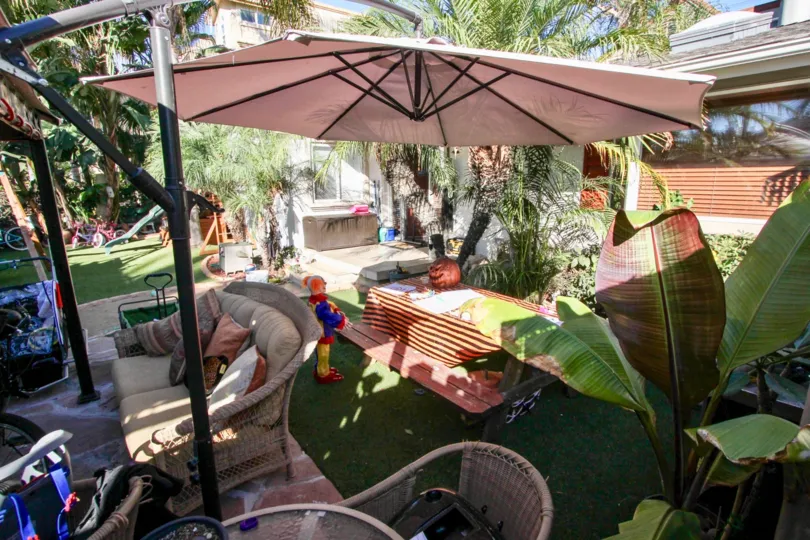 A sunny day in the area of Sunblend, outside, yard, umbrella, clown, table, patio