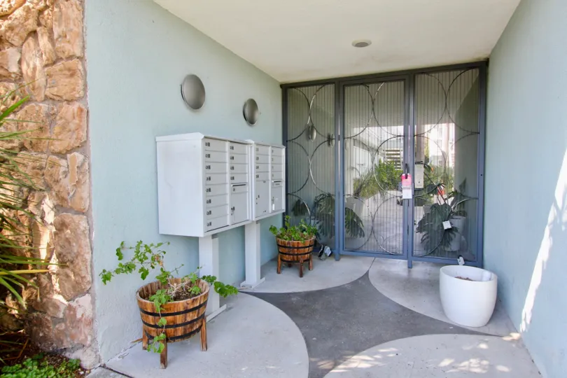 a warm day in the heritage on diamond with a house that has cupboard in the entry and also has two flower pots