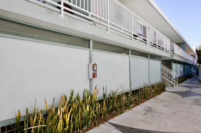 A sunny day in the area of The Heritage on Diamond, outside, sidewalk, fire extinguisher, balcony