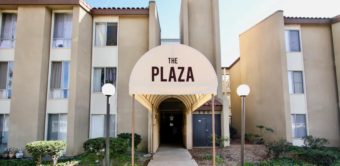 An entrance of a building in the The Plaza with beautiful plants.
