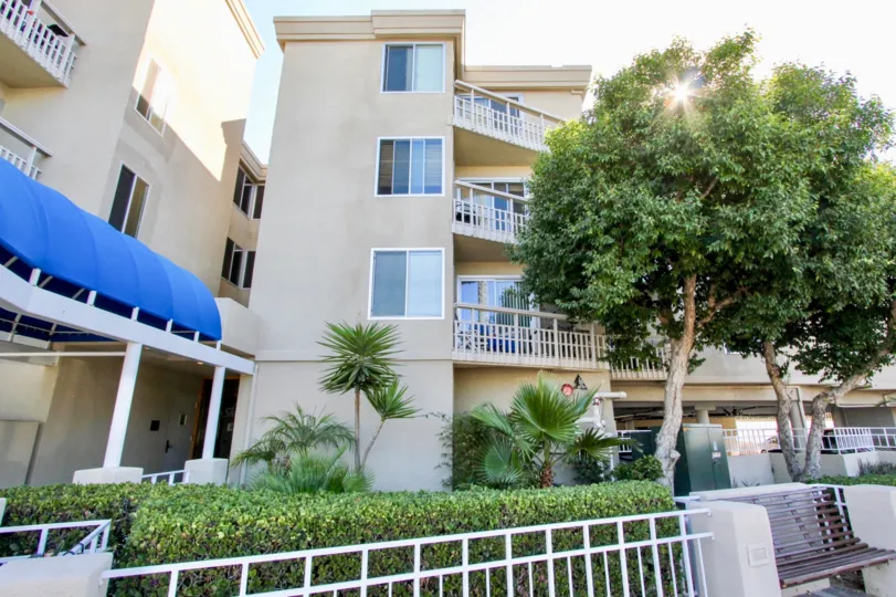 An exterior view of The Shores at Crown Point condo complex showing private balconies and front entrance awning.