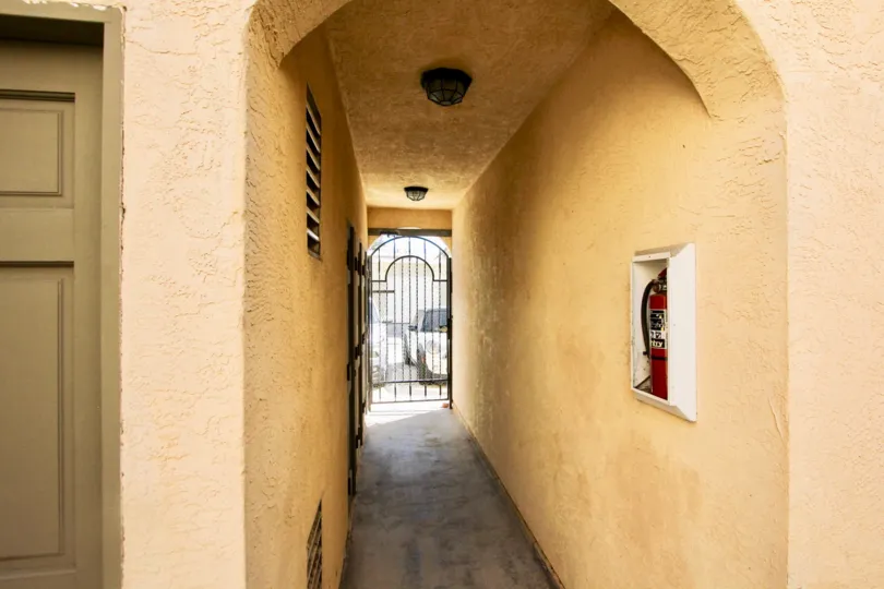a pleasant day in the thomas avenue condominiums with a building that has fire extinguiser at its way to gate