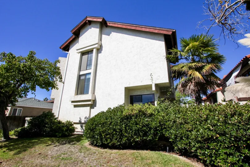 A white Townhouse on a sunny day in the Thomas Townhomes community