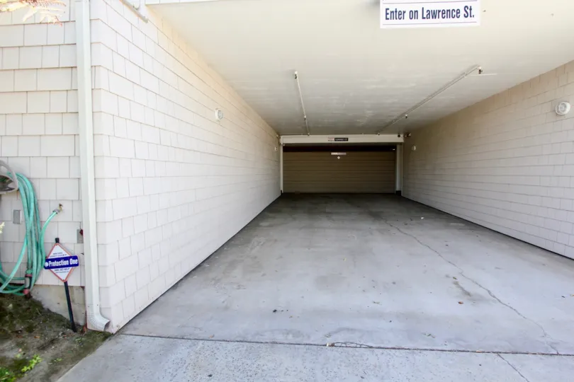 A sunny day in the area of At La Playa, driveway, garage, hose, sign, cement