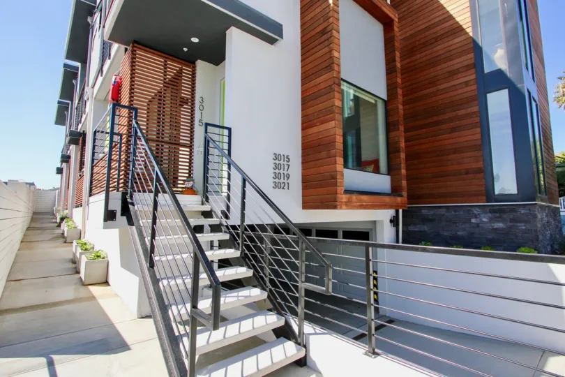 The sun shines on the Carleton community block of a town homes.