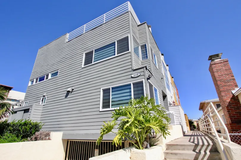 A corner unit with nice landscaping on a sunny day in the Harbor View Townhomes, Point Loma, CA