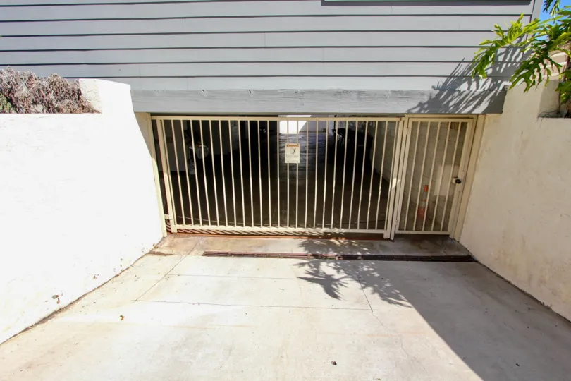 View of gated parking garage at Harboe View to homes on a sunny day