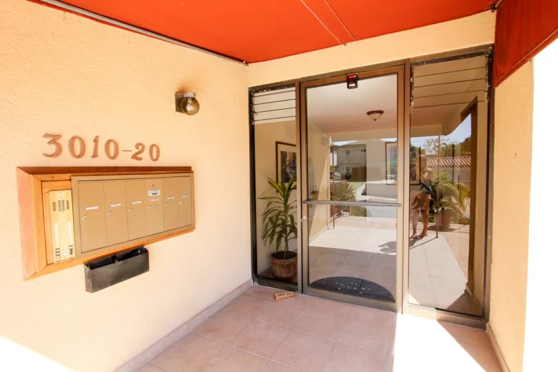 Mailboxes in the lobby of La Playa Plaza with orange interior exits to patio