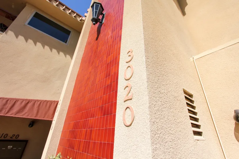 Imposing red brick facade and outdoor lights at La Playa Plaza